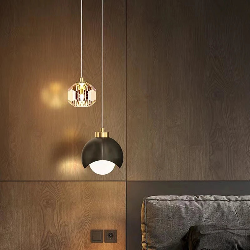 modern crystal pendant light hanging beside bedroom bed
